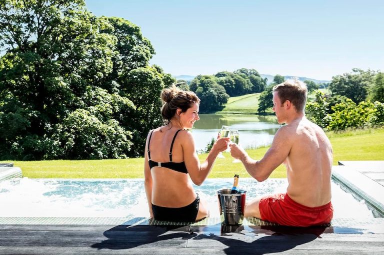 Coniston Spa Offer - couple cheers by the pool