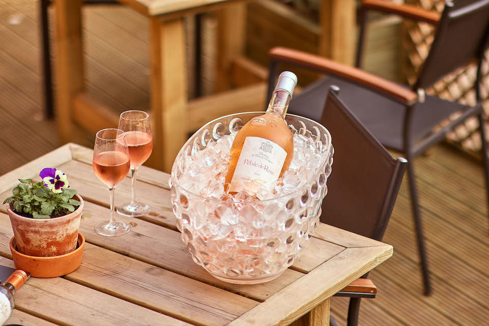 Three's A Crowd Harrogate rose bottle on terrace