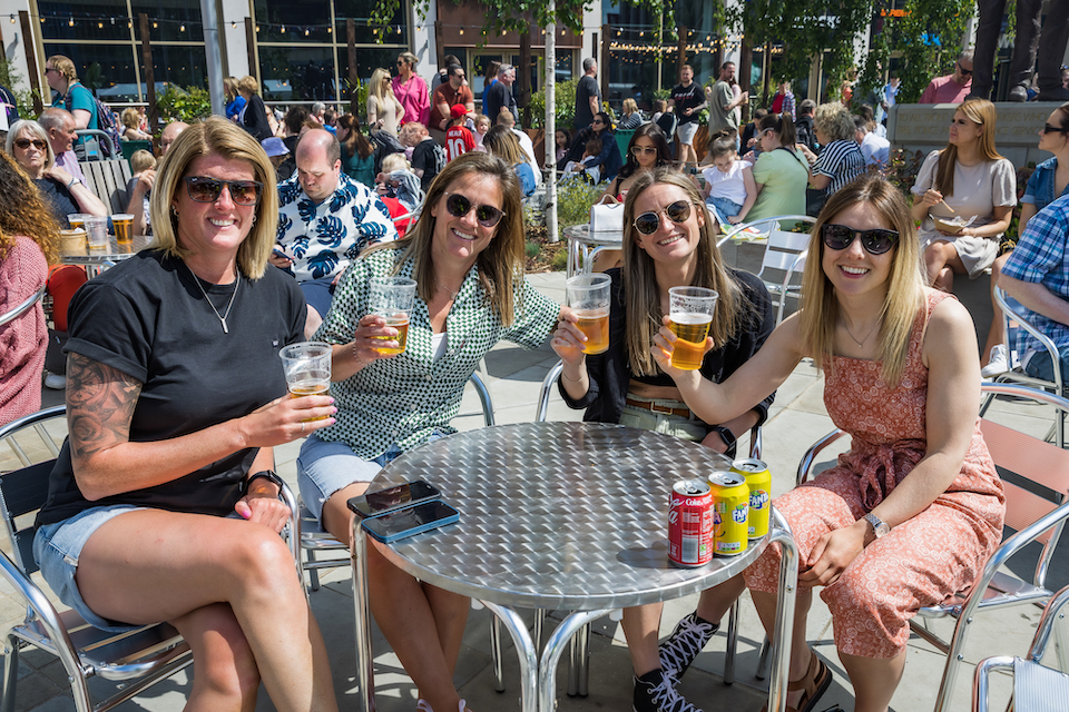 customers outside shopping centre with beer