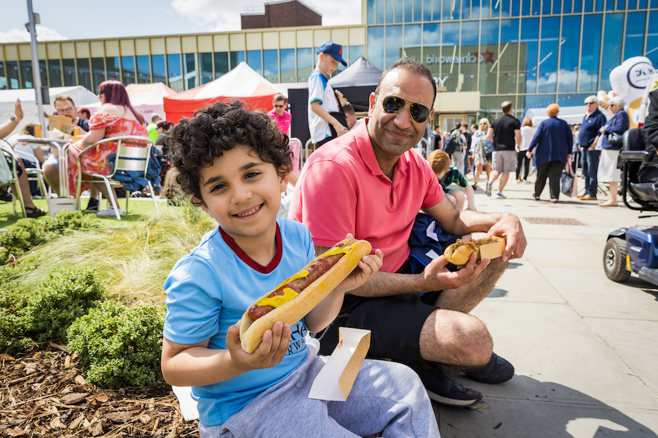 family eating hotdogs and street food